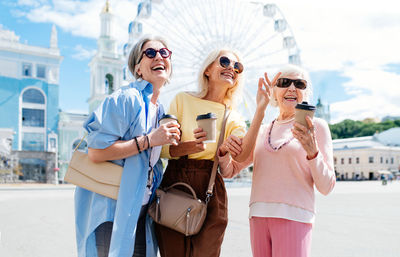 Portrait of female friends standing in city