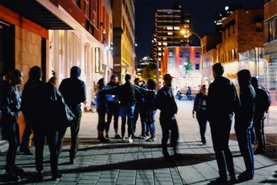 People on illuminated city at night