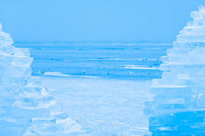 Close-up of snow against blue sky