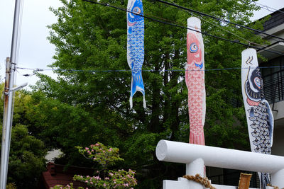 Low angle view of a sculpture hanging from tree