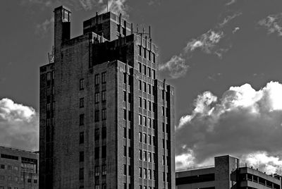 Low angle view of building against cloudy sky