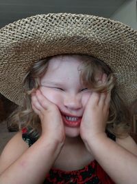 Close-up portrait of a girl wearing hat