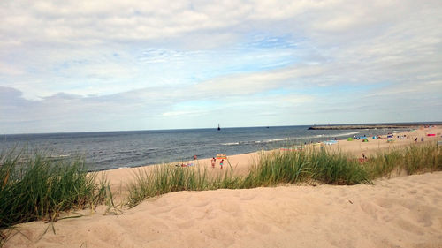 View of beach against cloudy sky