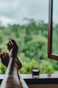 Midsection of man having glass window