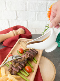 Close-up of woman preparing food on table