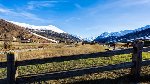 Scenic view of snowcapped mountains against blue sky