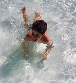 Happy boy playing in the swimming pool. freedom 