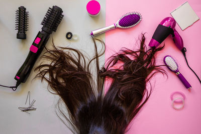 Woman with brown hair by personal accessories on table