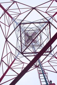 Low angle view of electricity pylon against clear sky