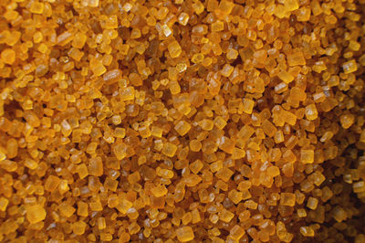 Close-up of brown cane sugar on a plane. texture and background of wholesome brown sugar