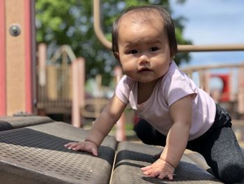 Cute girl looking away on equipment playground