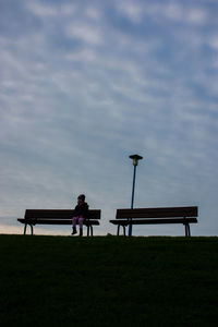 Girl sitting on bench in park