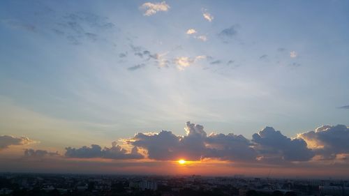 Scenic view of sunset over city