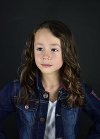 Portrait of girl against black background