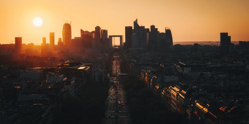 High angle view of illuminated cityscape at sunset