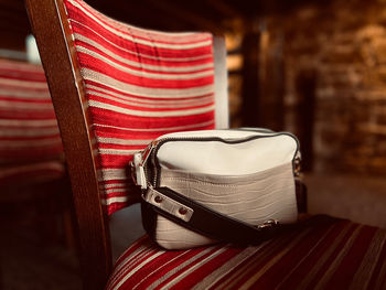 Handbag on a striped chair 