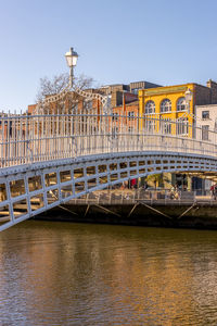 View of bridge over river against buildings