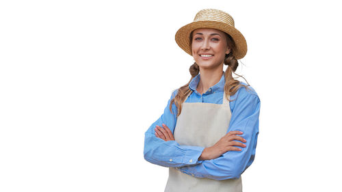 Portrait of a smiling young woman against white background