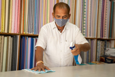 Portrait of man reading book at table