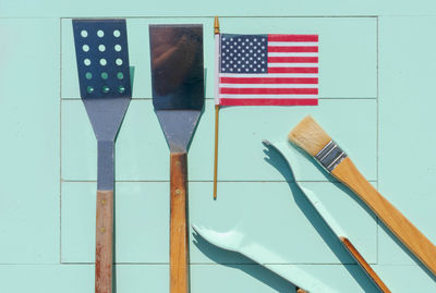 Directly above shot of cooking utensils with american flag on table