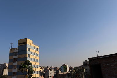 Exterior of buildings against clear blue sky