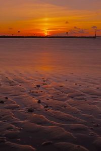 Scenic view of sea against romantic sky at sunset