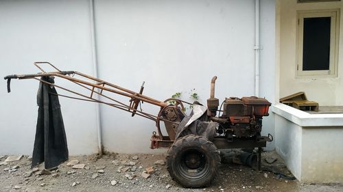 Abandoned cart against wall