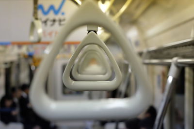 White handles hanging in train