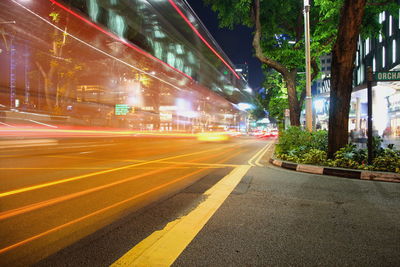 Light trails on road in city at night