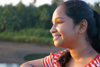 Close-up of smiling girl looking away