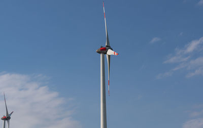 Low angle view of flag against blue sky