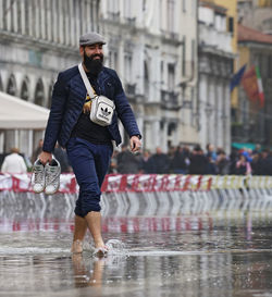 Full length of man in city during rainy season