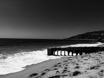 Scenic view of beach against clear sky