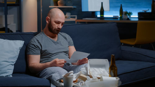 Portrait of young man using laptop while sitting at home