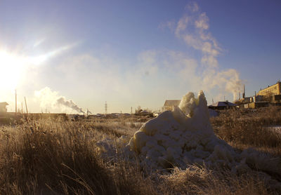 Scenic view of field against sky during winter