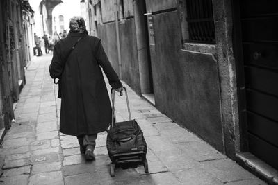 Full length rear view of man walking in city