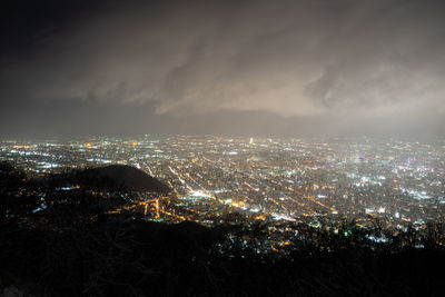 High angle view of illuminated buildings in city at night