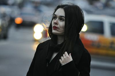 Close-up of young woman standing outdoors