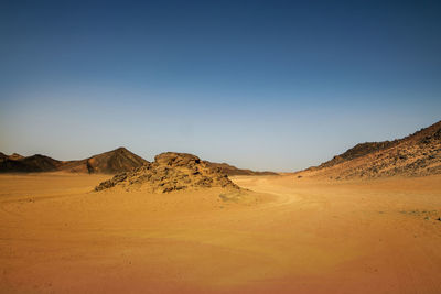 Scenic view of desert against clear sky