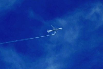 Airplane flying against blue sky