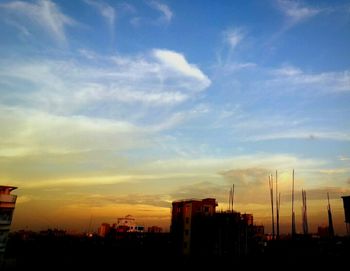 Low angle view of building against cloudy sky
