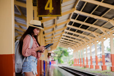 Full length of woman using mobile phone