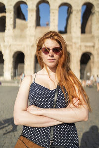 Confident tourist outside aged building