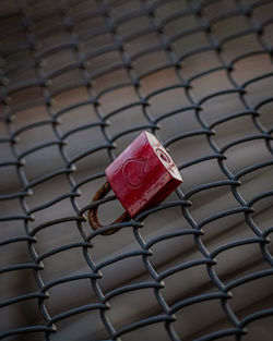 Close-up of padlock on metal grate