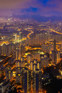 High angle view of city lit up at night