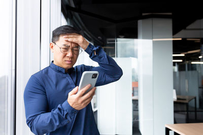 Portrait of young man using mobile phone