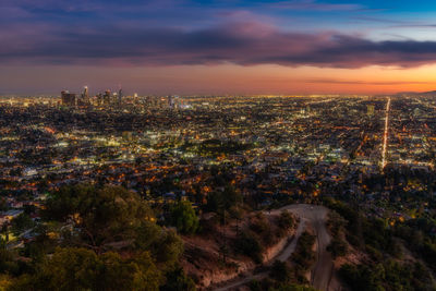 High angle view of illuminated buildings against sky at sunset