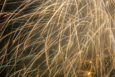 Low angle view of firework display at night