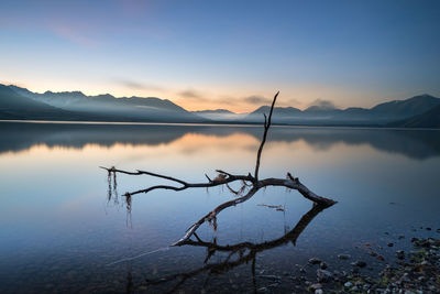 Scenic view of lake against sky during sunset