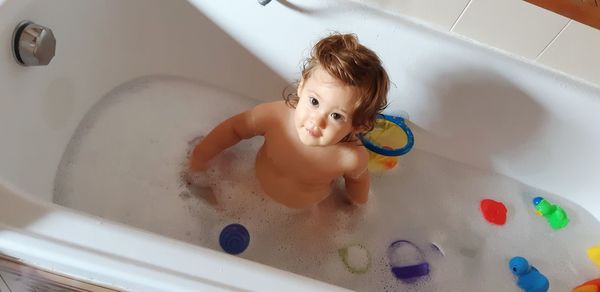 High angle portrait of cute baby girl in bathtub